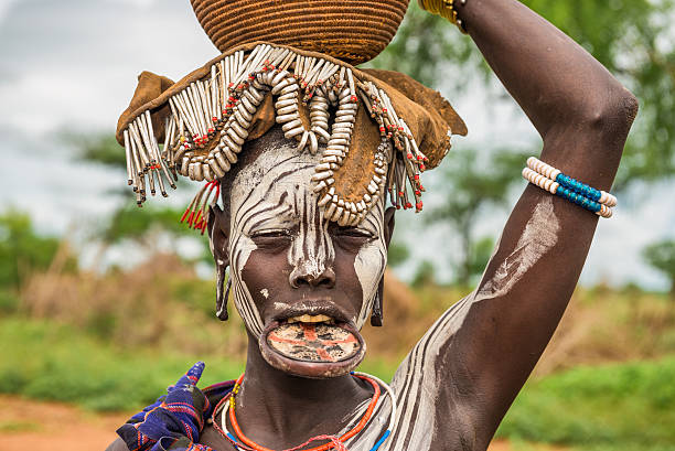 Woman from the african tribe Mursi, Omo Valley, Ethiopia Omo Valley, Ethiopia - May 7, 2015 : Woman from the african tribe Mursi with big lip plate in her village. omo river photos stock pictures, royalty-free photos & images