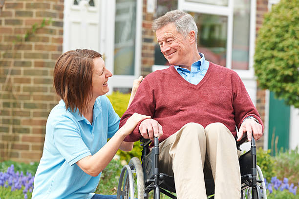 istock Carer With Senior Man In Wheelchair 484715049