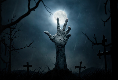 Halloween concept, dead man's hand coming out from the grave