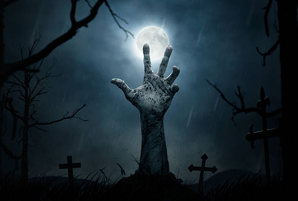 Zombie's hand Halloween concept, dead man's hand coming out from the grave monster back lit halloween cemetery stock pictures, royalty-free photos & images