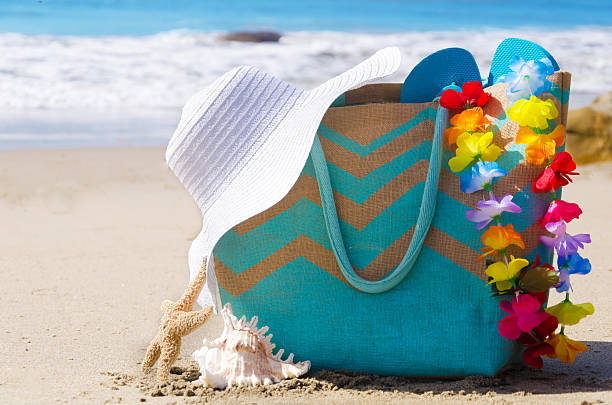 istock Beach bag with flip flops by the ocean 484716137