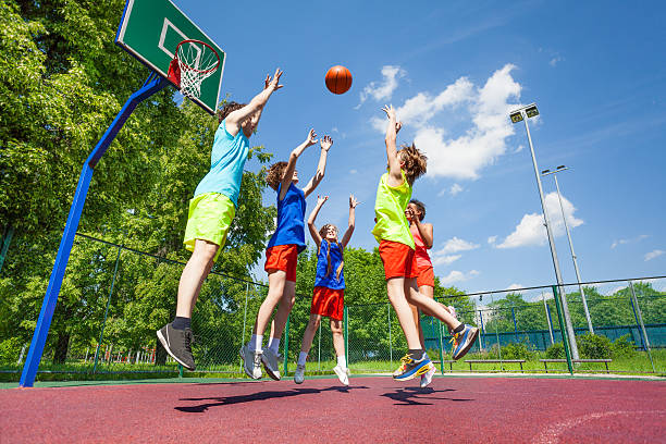 istock Children jump for flying ball during basketball 484716666