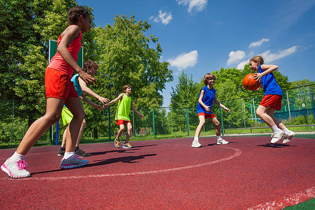 istock Teenagers team playing basketball game together 484716672