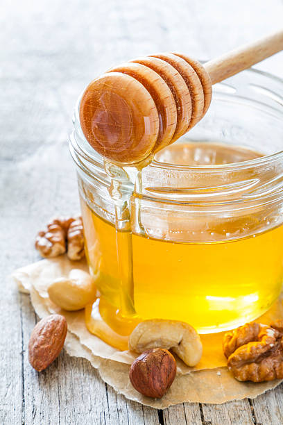 istock Honey and dipper selection of nuts 484717066