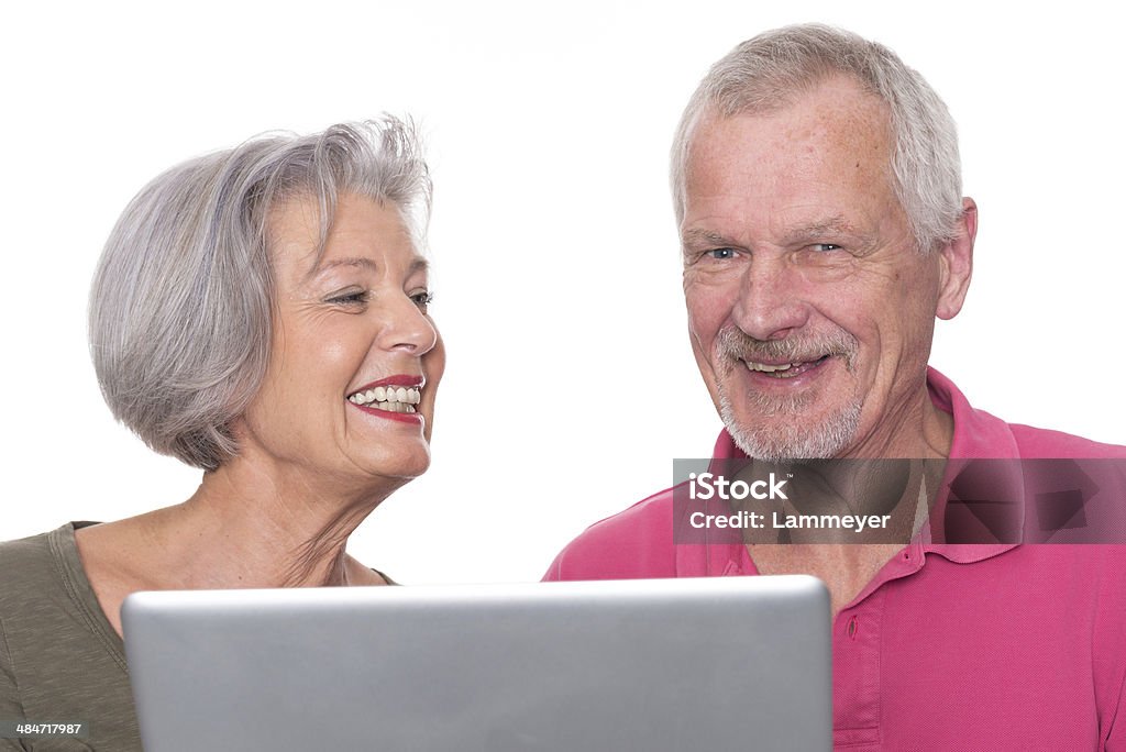 Senior couple with tablet Senior couple with computer in front of white background 60-69 Years Stock Photo