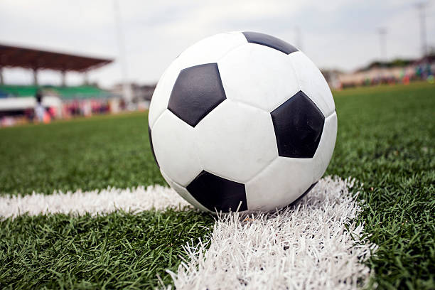 istock soccer ball on green grass 484718861