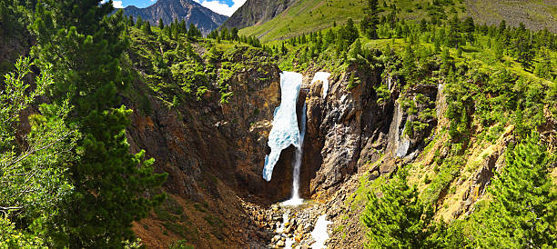 Summer view to waterfall with ice and snow. stock photo
