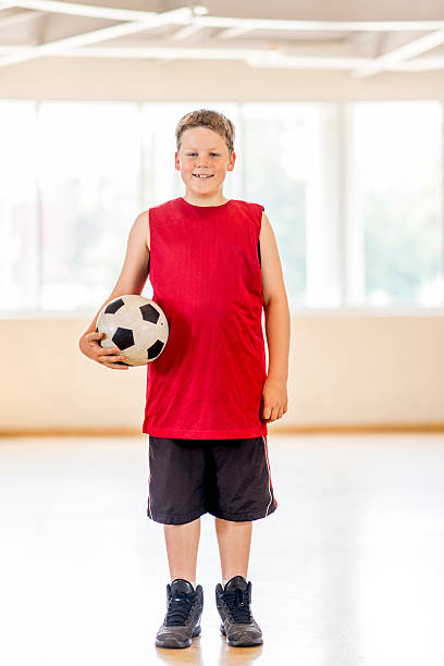 istock Boy Standing with Soccer Ball 484720836