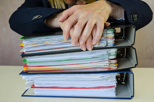 istock hands on pile of folders 484721724