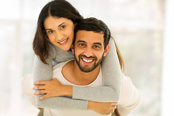 istock young indian couple having fun with piggyback 484721982