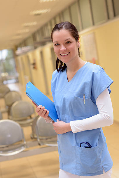 istock Nurse in hospital standing with patient file 484723120
