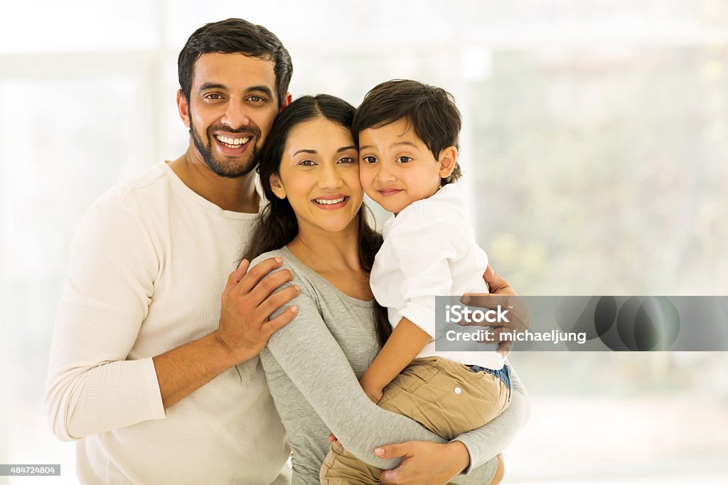 indian family of three portrait of happy indian family of three standing indoors Indian Ethnicity Stock Photo