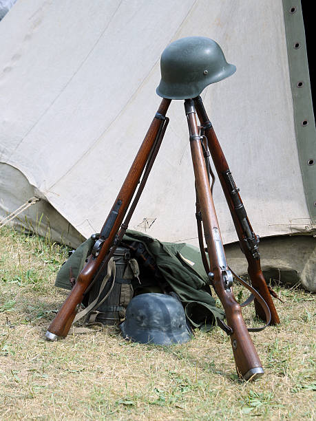 istock three old war rifles and helmets of dead soldier 484725882