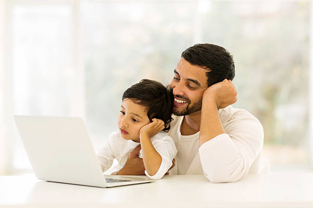istock indian man using laptop with his little boy 484726578