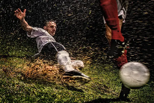 Two soccer players challenging for the ball, low angle view.