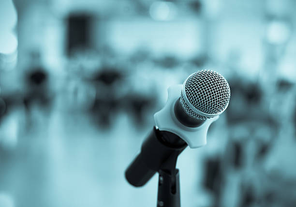 istock Close up of microphone in conference room on blurred background 484736582