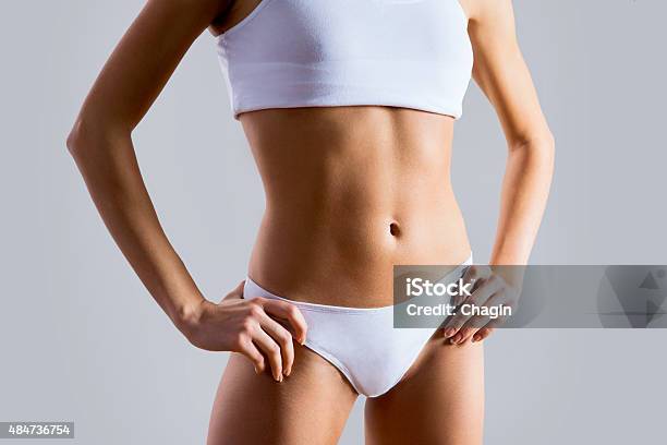 Slim Tanned Womans Body Stock Photo - Download Image Now - Torso, Women, Midsection