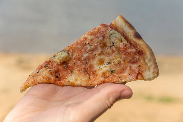 istock Fast food, pizza, on the beach 484737206