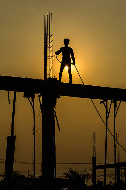 silhouette of constructionworker on constructionsite stock photo