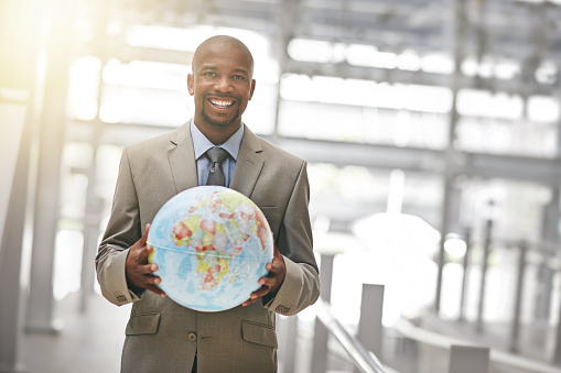 Cropped portrait of a businessman holding a globehttp://195.154.178.81/DATA/i_collage/pu/shoots/805421.jpg