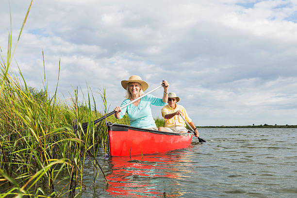 istock Senior couple canoeing on water 484740285