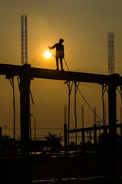 silhouette of constructionworker on constructionsite