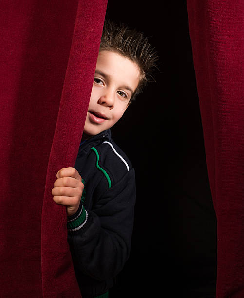istock Child appearing beneath the curtain 484740961