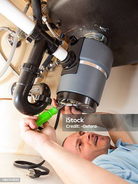 Installing Garbage Disposal Stock Photo - Download Image Now - Garbage Disposal Unit, Expertise, Plumber