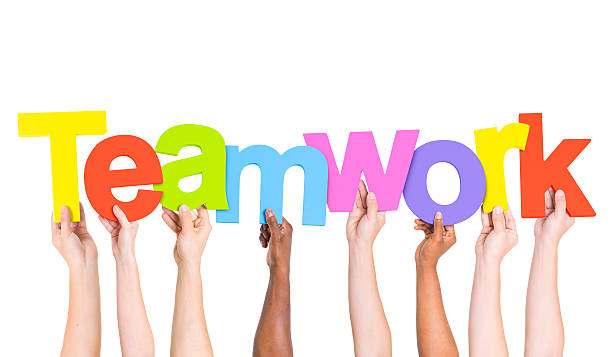 istock Multi-Ethnic Group Of People Holding The Word Teamwork 484741591