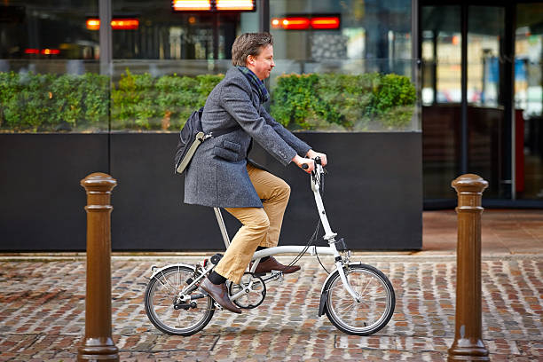 Mature businessman going to office by brompton cycle