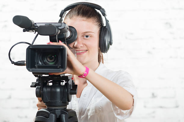 istock pretty young woman with a professional camera 484743042