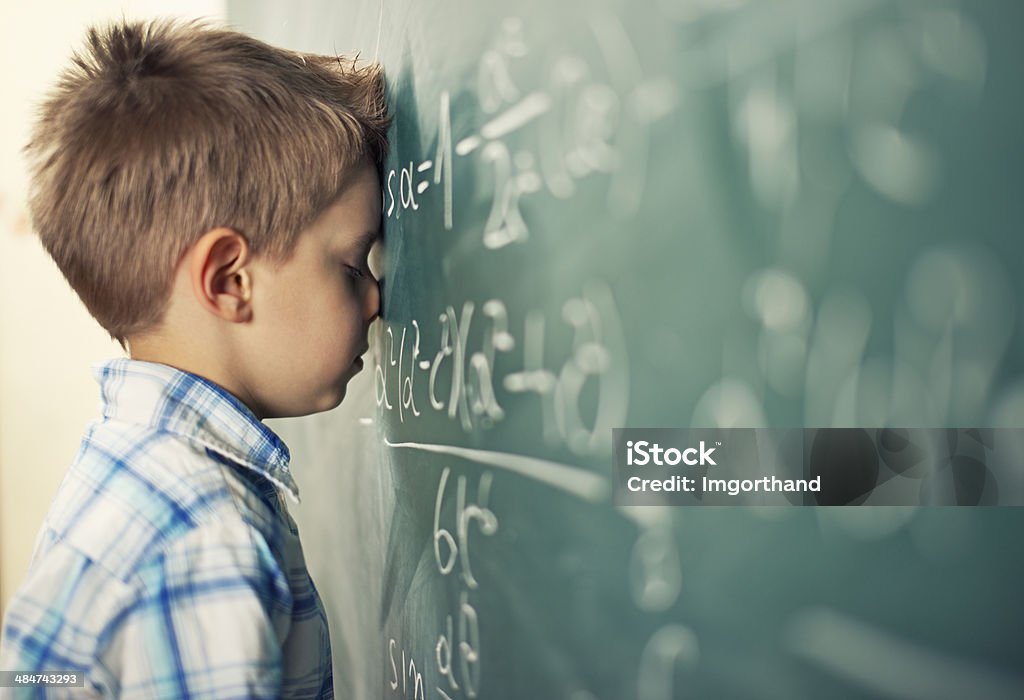 This is too hard Little boy in math class overwhelmed by the math formula. Child Stock Photo