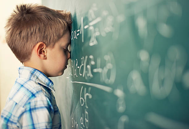This is too hard Little boy in math class overwhelmed by the math formula. mathematical symbol stock pictures, royalty-free photos & images