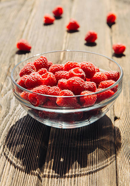 istock Ripe raspberries in bowl on a sunny day 484744638