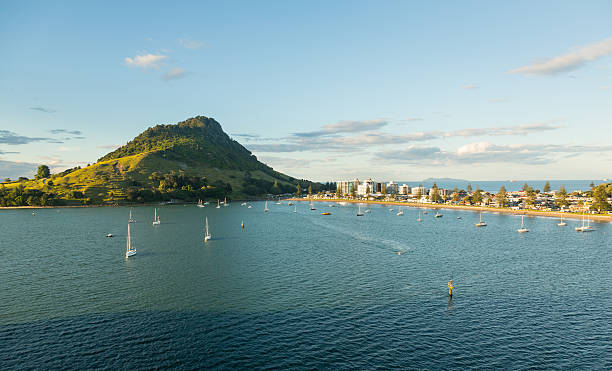The Mount at Tauranga in NZ The bay and harbour at Tauranga with calm water in front of the Mount mount maunganui stock pictures, royalty-free photos & images