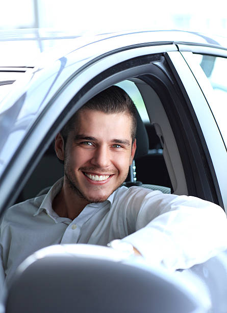istock Handsome man in his new car and smiling 484745957