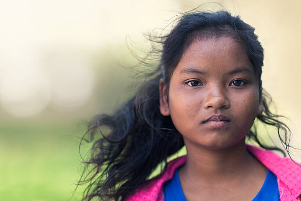 Cambodian girl portrait Portrait of a teenage cambodian girl with wind in her hair. sad 15 years old girl stock pictures, royalty-free photos & images