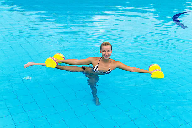 istock Woman is engaged aqua aerobics in water 484747143