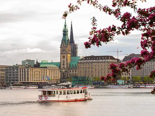 The Lake Binnenalster in Hamburg in Germany during spring time. In the toreground one of the famous alster ferrys.