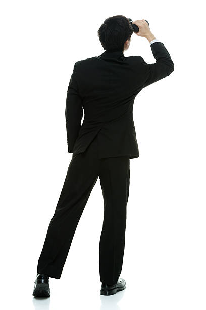 istock Rear view of businessman searching with binoculars 484749802
