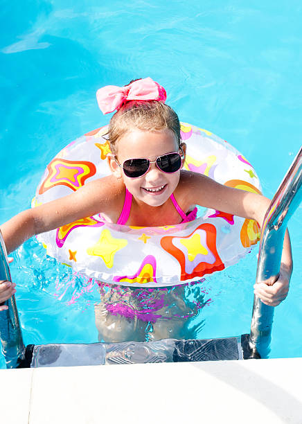 istock Smiling little girl in swimming pool 484750428