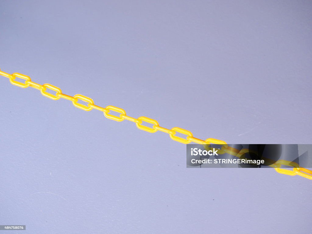Yellow chain barrier on grey background Yellow chain barrier on grey background, Melbourne 2015 Chain - Object Stock Photo