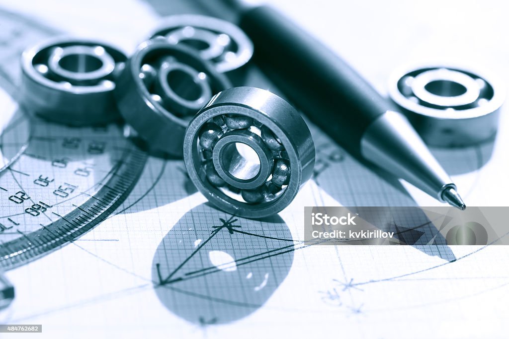 Ballbearings On Draft Engineering concept. Few ball bearings near ruler and pen on graph paper background 2015 Stock Photo