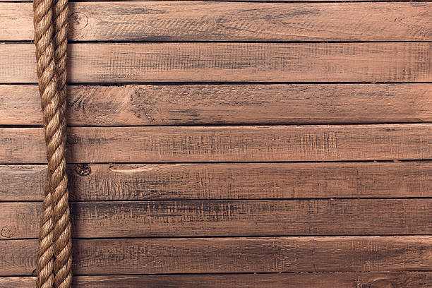 istock Rope on old wooden board vertical 484763149