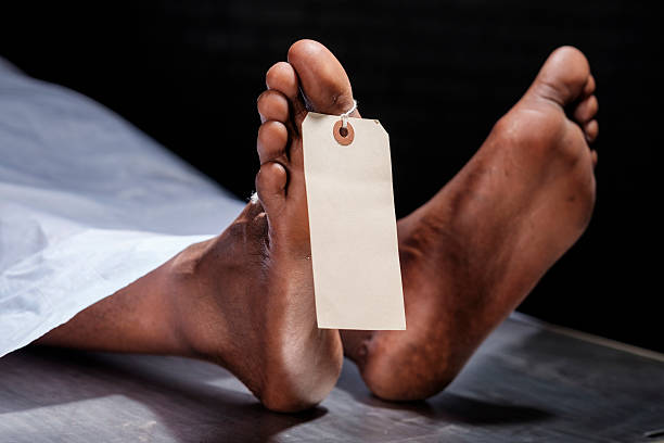 Dead Body A close-up of the foot of a dead person in a morgue. A blank tag is attached to the toe. morgue stock pictures, royalty-free photos & images