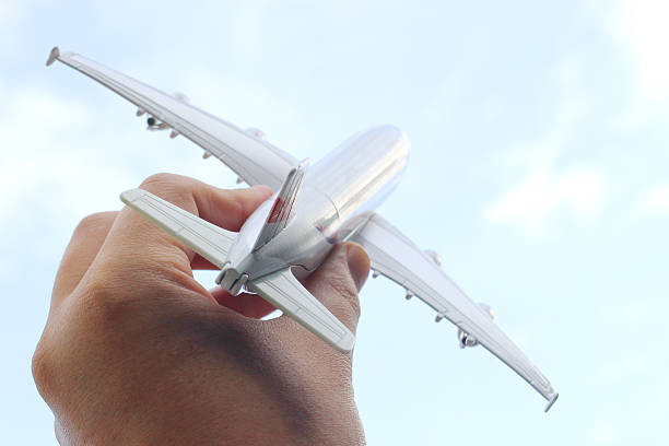 istock hand hold the aroeplane on blurred background 484763560