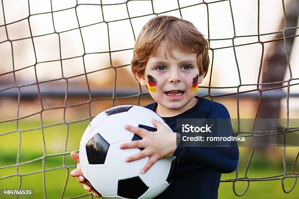 Blond Boy Of 4 Playing Soccer With Football Onl Field Stock Photo - Download Image Now