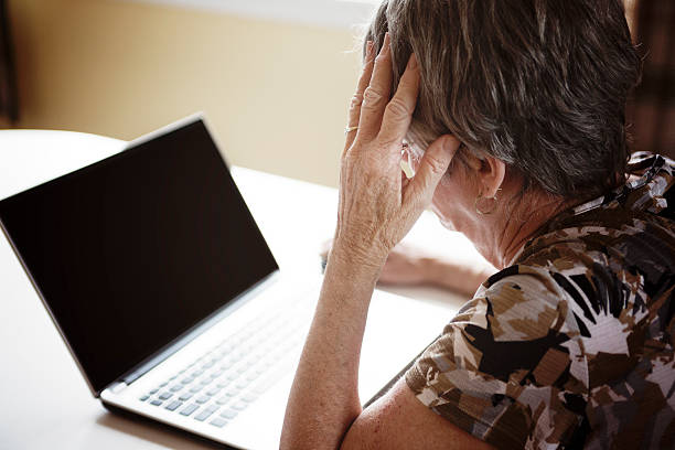 istock senior woman working on her laptop in her kitchen table 484766878