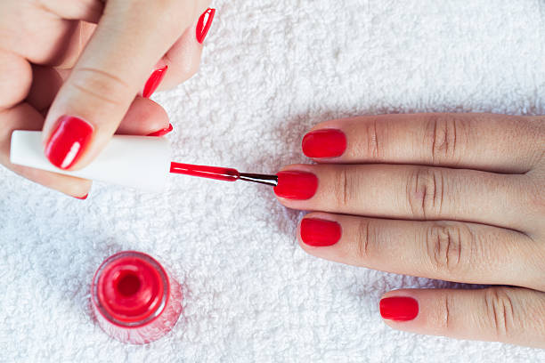 istock Manicure - Beautiful manicured woman's nails with red nail polis 484770414