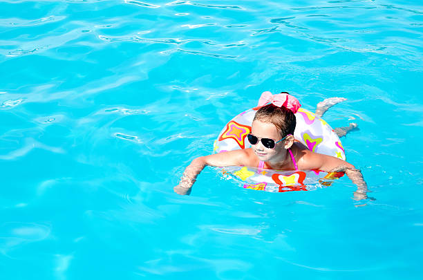 istock Smiling little girl in swimming pool 484770854